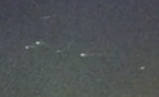 Source frame for Crossett source-video lead: live weather camera records reported lights over Arkansas wildfire