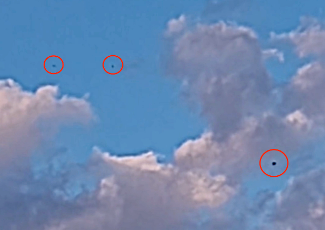 Riverdale, Illinois source-video lead: black amorphous objects reported over a sunny sky